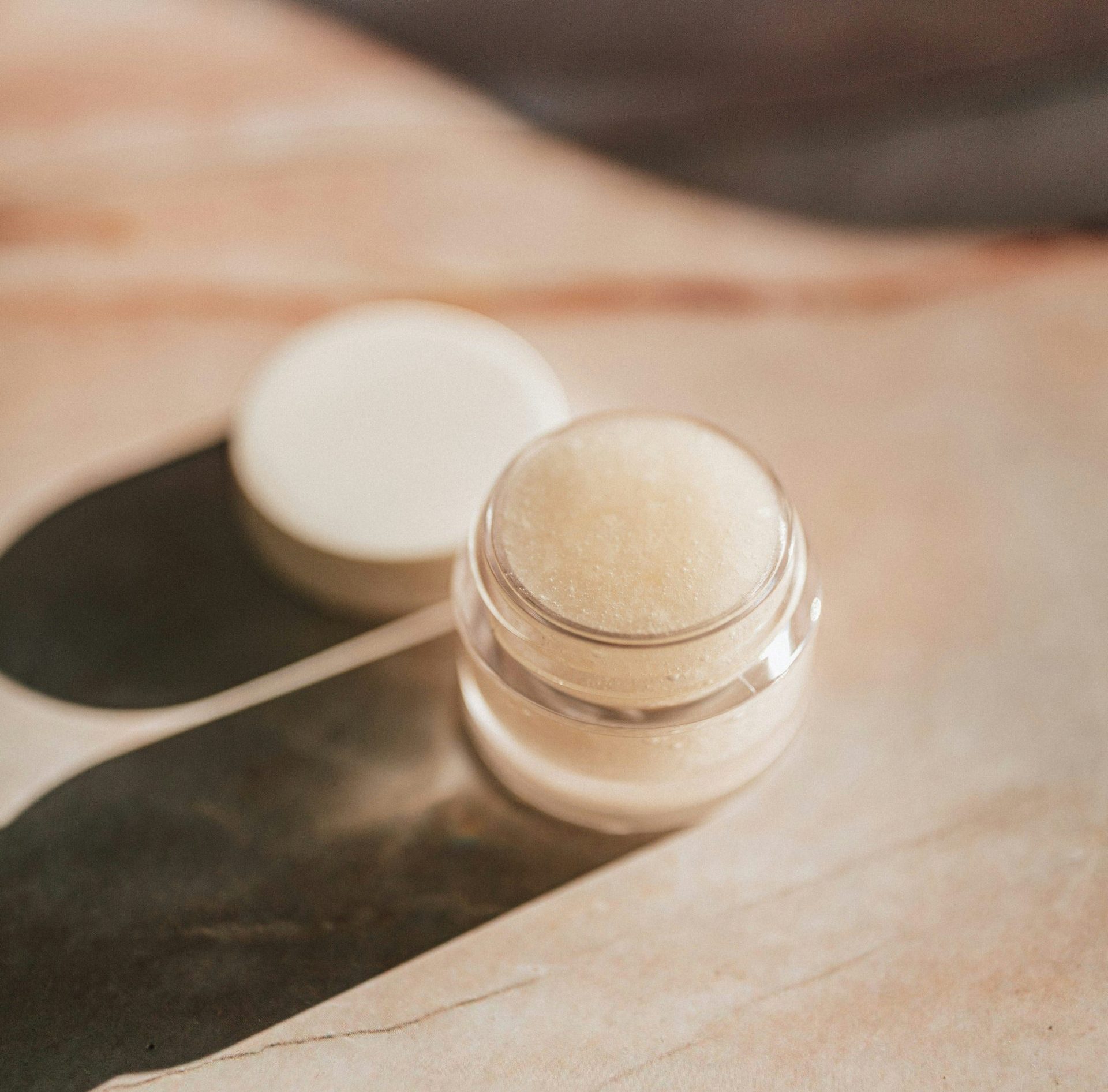 white round plastic container on brown paper
